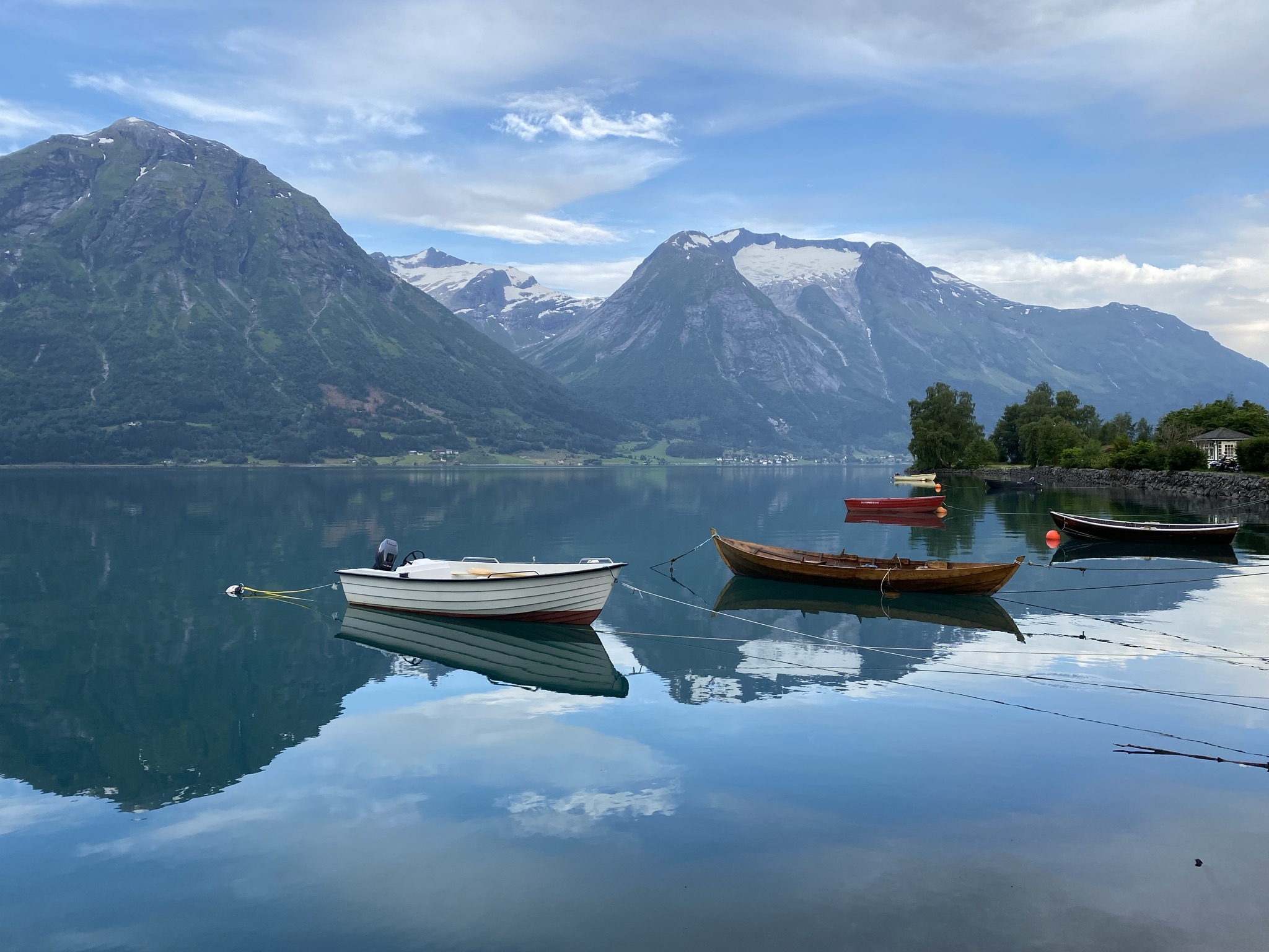 Boats in the lake with mountains in the background